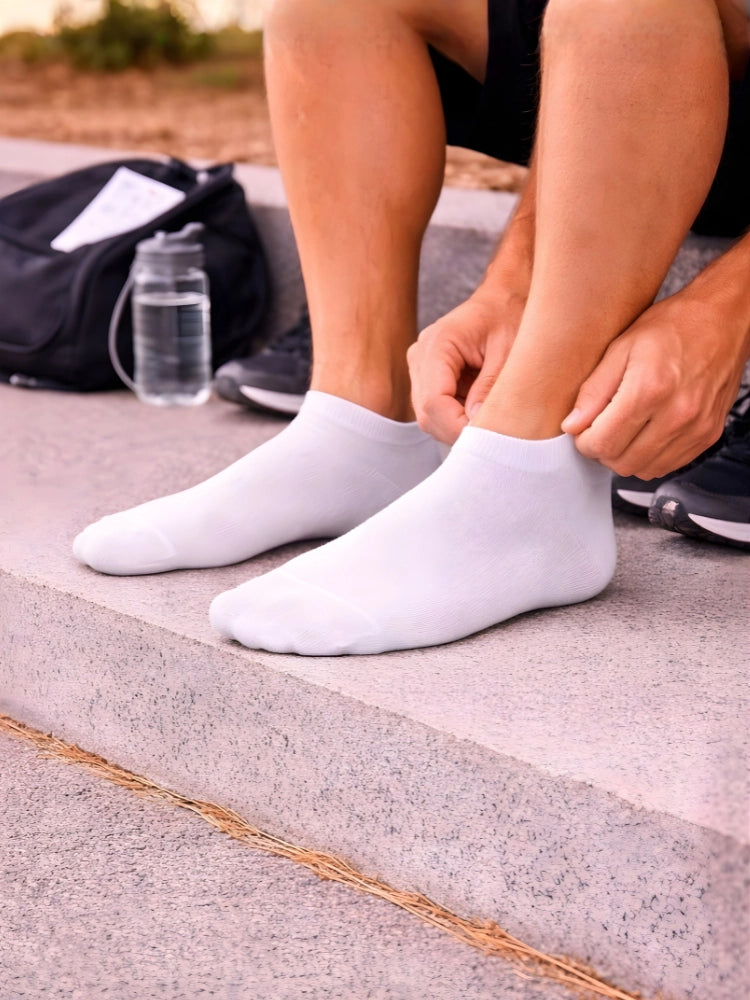 Person wearing white socks tying shoelaces outdoors on a paved surface.

Classic white socks for casual and activewear by Stylewar