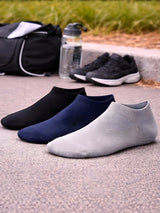Three pairs of ankle socks in black, blue, and gray on a concrete surface with a water bottle and bag in the background.

Active Star Men's Trainer Socks Black, Navy, Grey