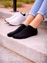 Person wearing black socks and white sneakers on a concrete surface.

Black ladies trainer socks perfect for casual wear and activewear by Stylewar