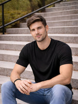 Man sitting on steps wearing a black t-shirt and blue jeans

Black men’s classic crew neck T-shirt casual everyday wear by Stylewar