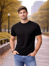 Man wearing a black t-shirt and blue jeans standing in an urban park setting

Men’s black crew neck T-shirt by Stylewar