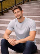 Man sitting on steps wearing a light gray t-shirt and dark pants

Men’s grey crew neck half sleeve T-shirt by Stylewar