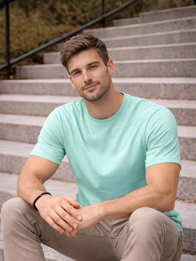 Man wearing a light blue t-shirt sitting on steps outdoors

Green men’s classic crew neck T-shirt casual everyday wear by Stylewar