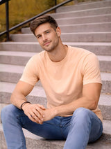Man sitting on steps wearing a light pink t-shirt and blue jeans

Light peach men’s classic crew neck T-shirt casual everyday wear by Stylewar