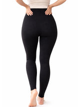 Person wearing black leggings on a white background