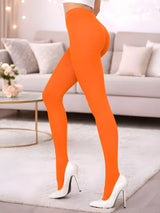 Person wearing bright orange leggings and white high heels in a living room setting. Adult Crazy Chick Opaque Orange Tights