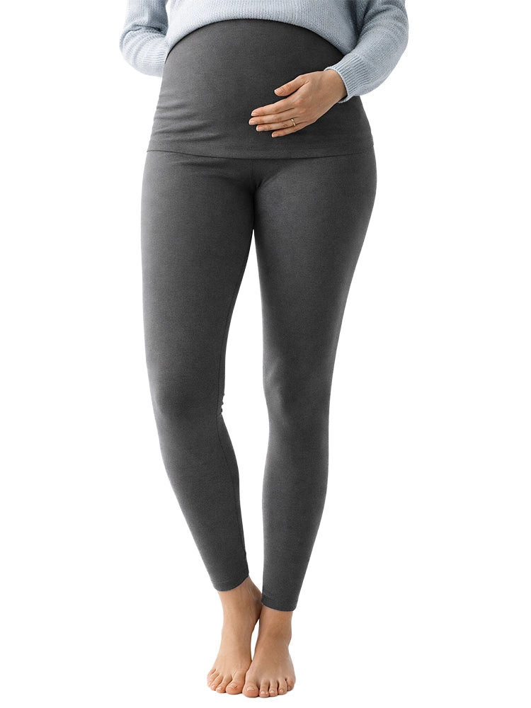 Person wearing gray maternity leggings on a white background
