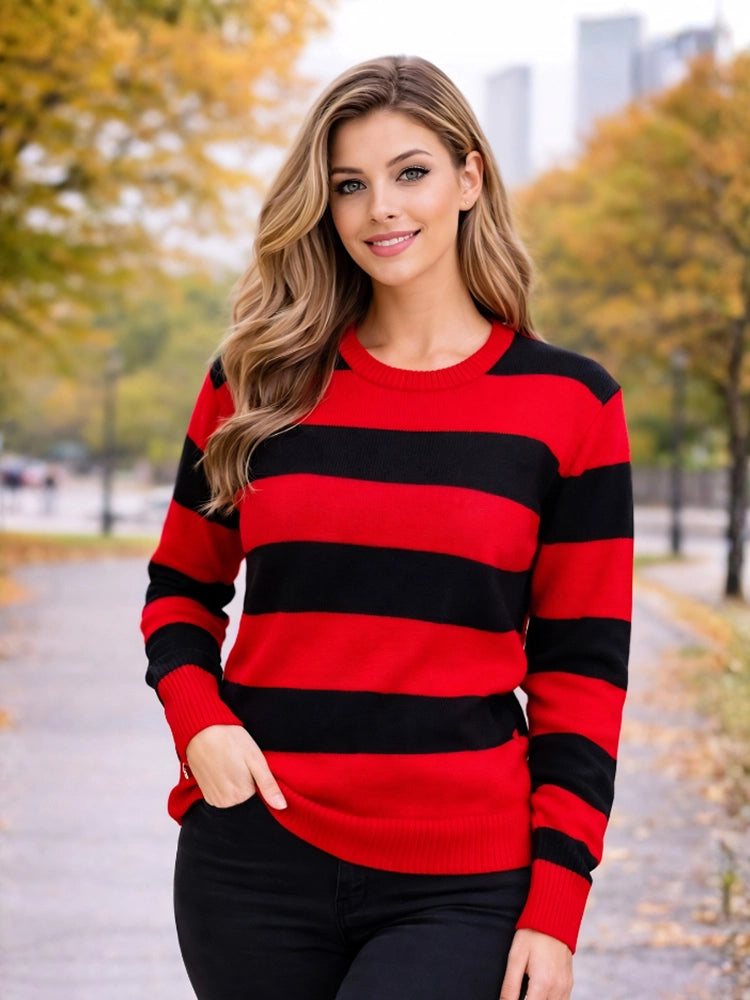 Woman wearing a red and black striped sweater in an outdoor setting with trees and buildings in the background. Women’s Red & Black Stripe Knitted Jumper