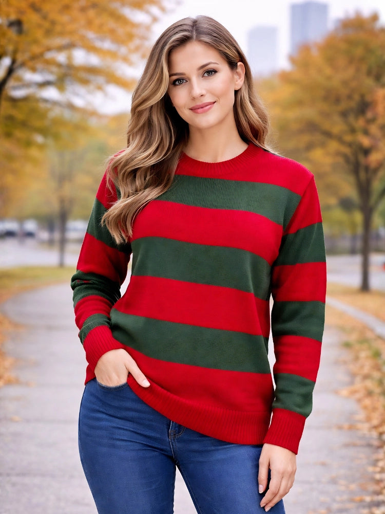 Woman wearing a red and green striped sweater in an autumn setting. Women’s Red & Green Stripe Knitted Jumper