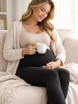 Pregnant woman sitting on a couch holding a mug in a cozy living room.

Women's Black Maternity Leggings Stretchy Cotton Breathable Tights