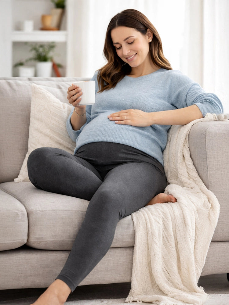 Pregnant woman sitting on a couch holding a mug, wearing a light blue sweater and dark gray leggings.

Women's Charcoal Maternity Leggings Stretchy Cotton Breathable Tights
