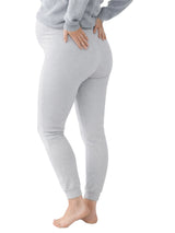 Person wearing gray leggings on a white background