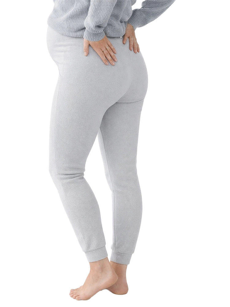 Person wearing gray leggings on a white background